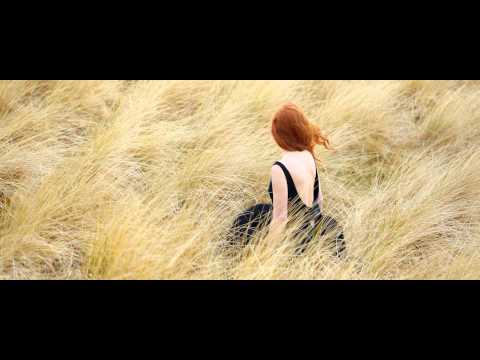 Woman walking through a field in the Love Story campaign